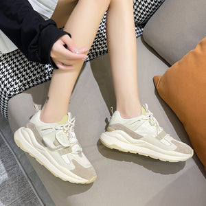 Women's leather colorblock running sneakers in black, orange, and khaki with lace-up closure