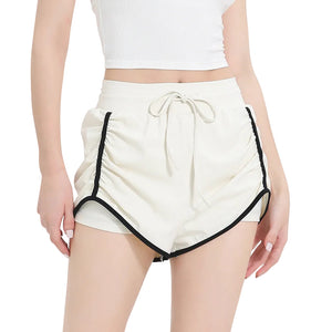 Women's three-quarter length sports shorts in black, milk white, and grass green