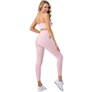 Women's two-piece yoga set with moisture-wicking top and leggings in multiple colors