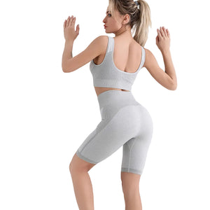 Sports bra and shorts workout set in gray, blue, and purple colors