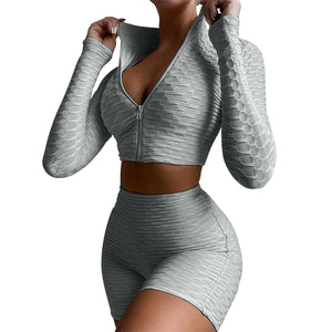 Women's yoga workout set with long sleeve zipper top and high waist shorts in multiple colors