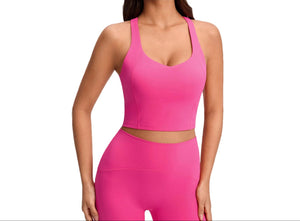 Women's push-up sports bra with breast pads in pink, white, and black colors