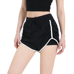 Women's three-quarter length sports shorts in black, milk white, and grass green