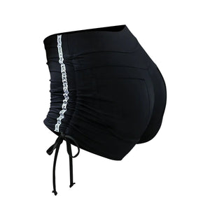 Women's moisture-wicking sports shorts in black, red, and grey with lace-up hips