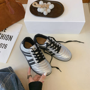 Women's versatile lightweight training sneakers in black, silver, and beige with lace-up closure