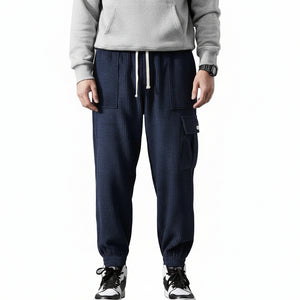 Men's elastic anti-wrinkle casual pants in tapered fit shown from multiple angles