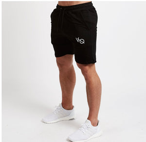 Men's cotton athletic five-point shorts in black, gray, and khaki colors