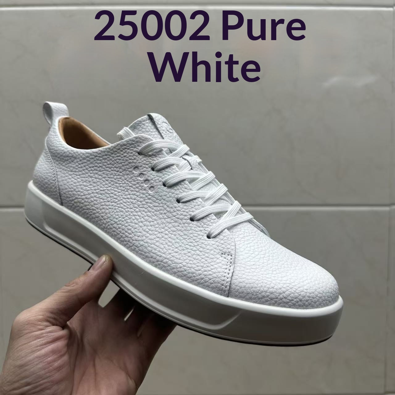 Men's casual leather sneakers in white and black with rubber sole and front lacing