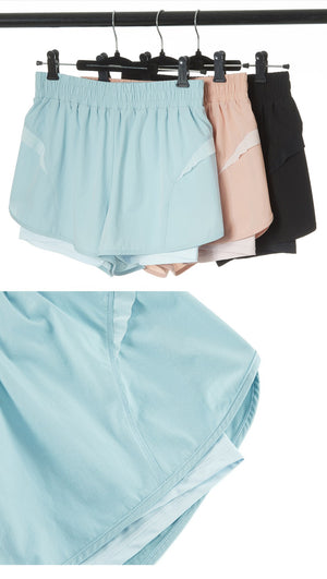 Women's loose mid waist sports shorts in black, silver powder, and moon white colors