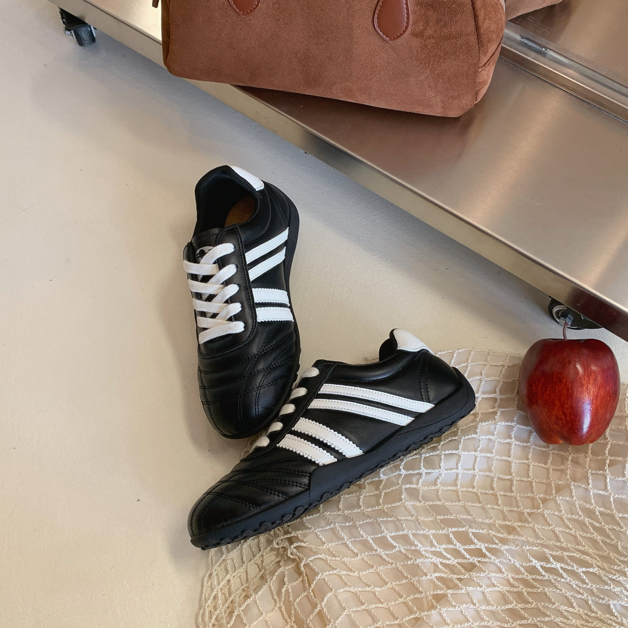 Women's versatile lightweight training sneakers in black, silver, and beige with lace-up closure