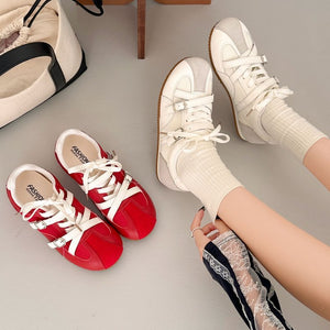 Women's retro high rise thick soled training shoes in red and beige with lace-up closure