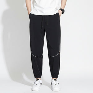 Men's tapered casual pants in gray, black, and army green colors