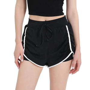 Women's three-quarter length sports shorts in black, milk white, and grass green