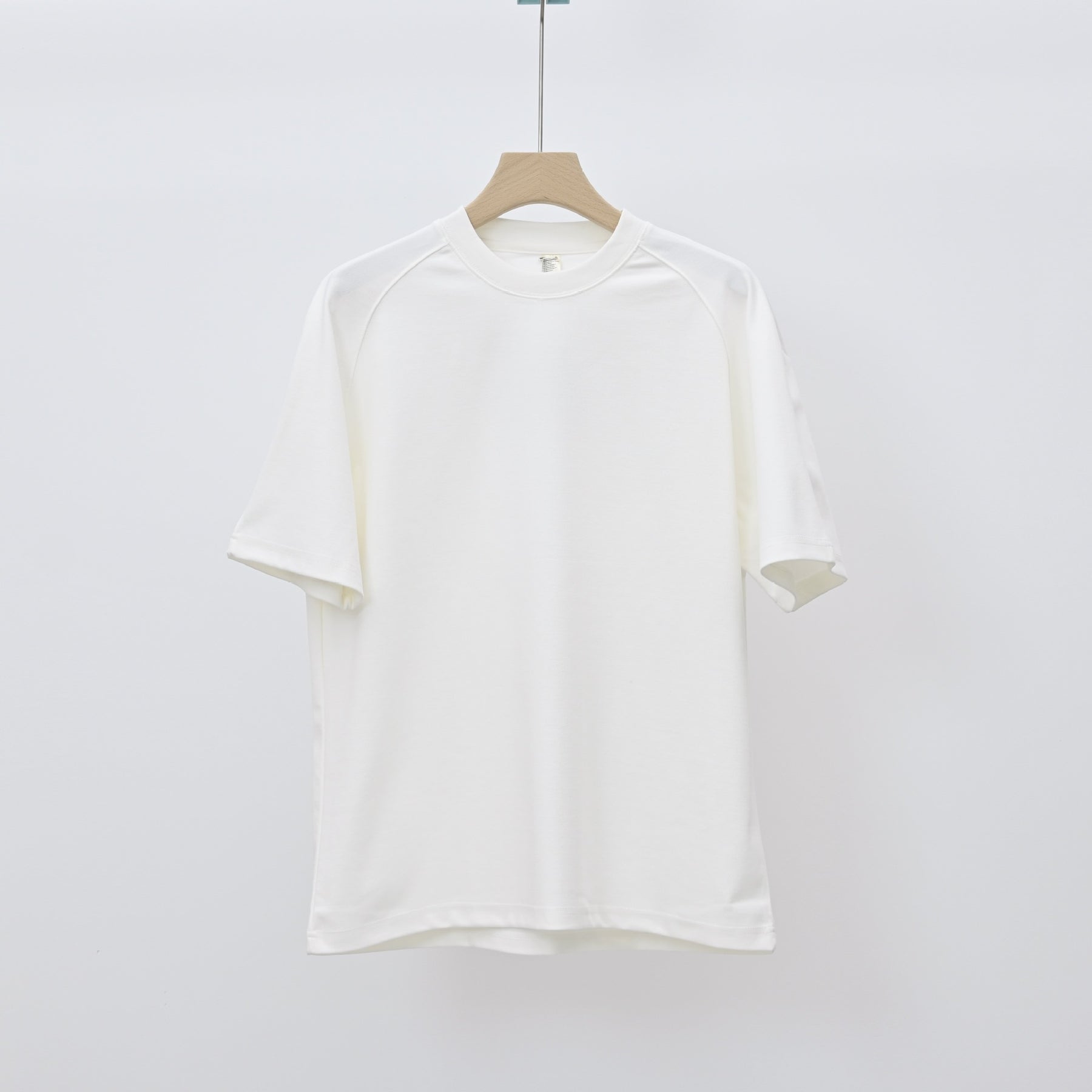 Men's loose-fit patchwork t-shirt in assorted colors with short sleeves and appliqué detailing