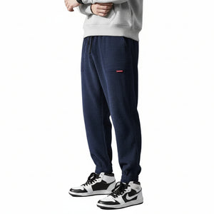 Men's elastic anti-wrinkle casual pants in tapered fit shown from multiple angles