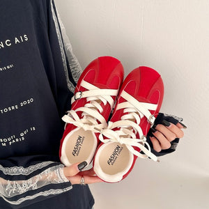 Women's retro high rise thick soled training shoes in red and beige with lace-up closure