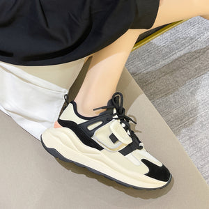 Women's leather colorblock running sneakers in black, orange, and khaki with lace-up closure