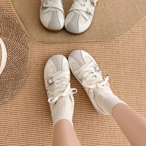 Women's retro high rise thick soled training shoes in red and beige with lace-up closure