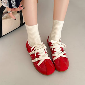 Women's retro high rise thick soled training shoes in red and beige with lace-up closure